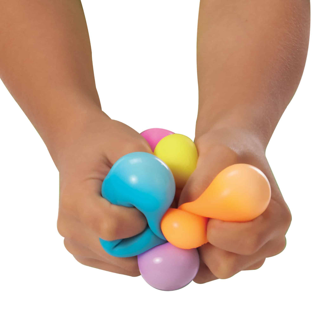 Two hands squeezing 6 NeeDoh Teenie NeeDoh