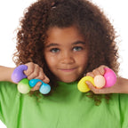 Girl squeezing 6 Rainboh Teenie NeeDoh